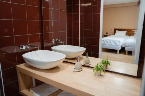 a bathroom with a white sink and a mirror at L'Azimut in Senez