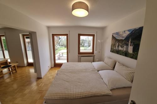 a bedroom with a large bed and a couch at Richters Alpen Appartement in Buchenberg
