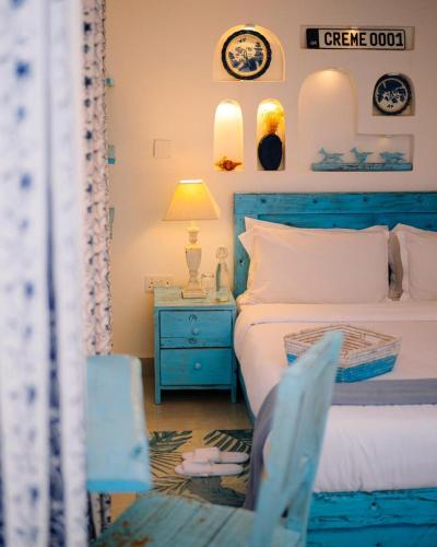 a bedroom with a blue bed and a blue chair at 2 Bedroom en-suite studios by The Prime Escape in Arusha