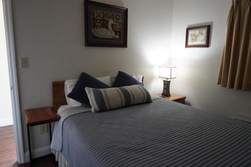 a bedroom with a large bed with blue pillows at River Place Condos #508 2BD in Pigeon Forge