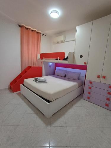 a bedroom with a bed with red and white furniture at The Samantha Guest House in Santo Stefano di Magra