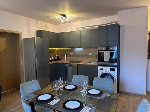 a kitchen with a table and chairs and a kitchen with a table and a kitchen at Alenik Private Apartment -Pamporovo in Pamporovo