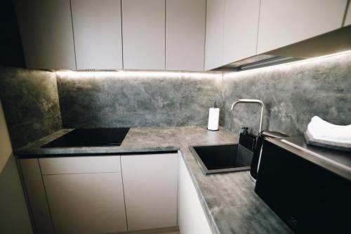 a kitchen with a sink and a counter top at MD Apartment in Rēzekne