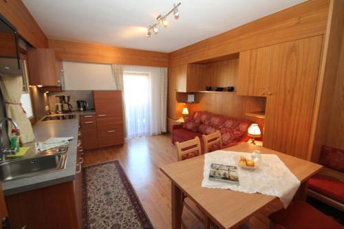 a kitchen and living room with a table and a couch at Haus Stefan in Längenfeld