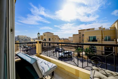a balcony with chairs and a view of a city at Studio - Private - Abu Dhabi in Abu Dhabi