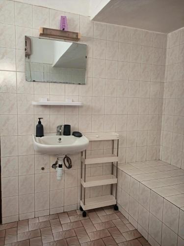 a white bathroom with a sink and a shower at Cloud9 Lomé in Lomé