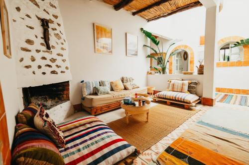 a living room with a couch and a fireplace at Surf HouseMaroc in Essaouira