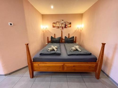 a bed with two pillows on it in a room at L&L Skaters Home in Langenlipsdorf