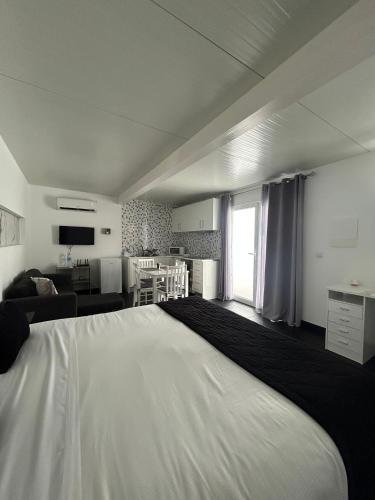 a bedroom with a large white bed in a room at The Rock Guest House in Ponta Delgada