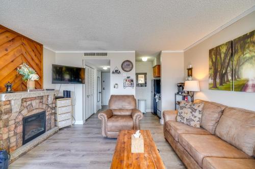 a living room with a couch and a fireplace at Studio about 3 Mi to Great Smoky Mountain Natl Park! in Gatlinburg