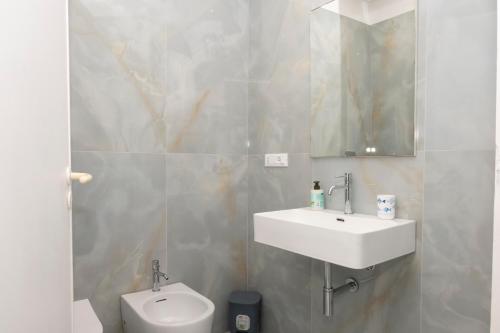 a bathroom with a sink and a toilet at Casa Blu sul mare e centralissima in San Vito lo Capo