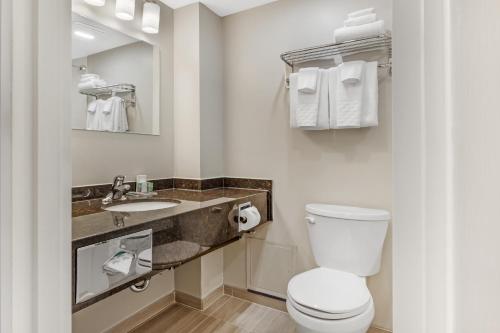 a bathroom with a toilet and a sink at Best Western Colonel Butler Inn in Niagara-on-the-Lake