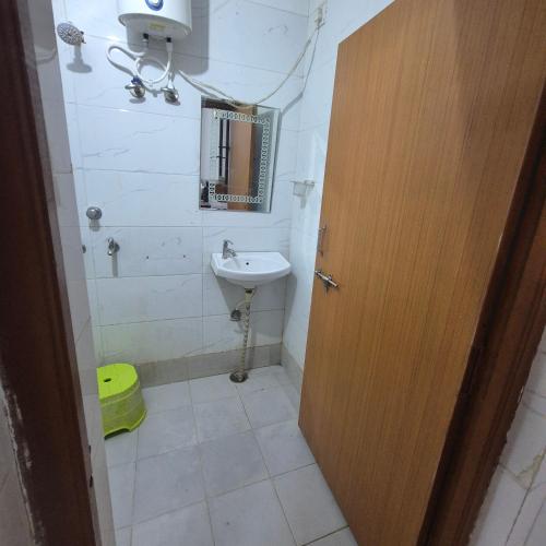 a bathroom with a sink and a mirror and a toilet at Sky Desert Safari With Swimming Pool in Jaisalmer