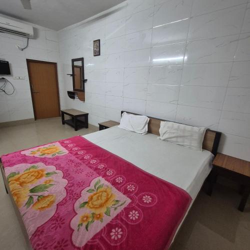 a bedroom with a bed with a red blanket at Sky Desert Safari With Swimming Pool in Jaisalmer