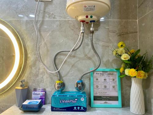 a light on a bathroom counter next to a sink at The Rudraya - Suites in Greater Noida