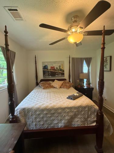 a bedroom with a bed with a ceiling fan at Palace priv april in Decatur