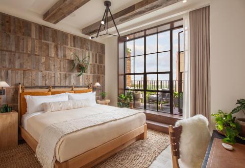 a bedroom with a bed and a large window at 1 Hotel Central Park in New York