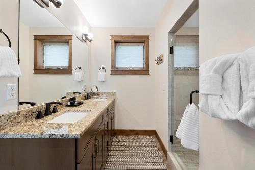 a bathroom with two sinks and a shower at Lakota Villa 607 Next to WP Resort I Private Hot Tub I Amazing Views I Activity Program in Winter Park
