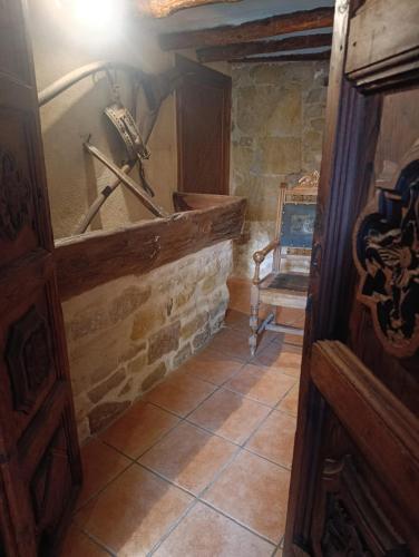 a room with a stone wall and a stone floor at CASA VICENT in Valderrobres