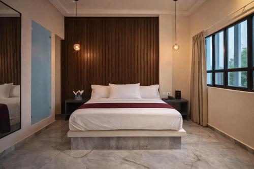 a bedroom with a large bed and a large window at Hotel Olimpica Boutique in Mexico City