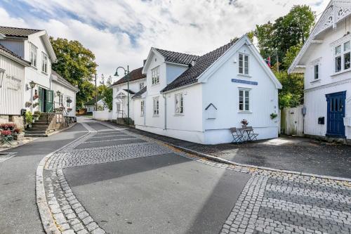 a street with white buildings on a cobblestone road at Villa house in Son Old Town - Oslo Fjord in Vestby