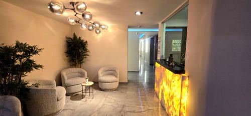 a lobby with chairs and a fireplace in a building at Hotel Olimpica Boutique in Mexico City