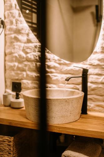 a bathroom sink with a faucet and a mirror at Domek SzumiSosna2 in Życiny