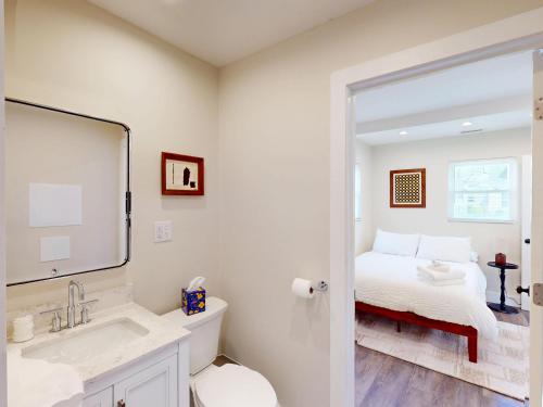 a bathroom with a bed and a sink and a mirror at The Nook on Landess in Marion