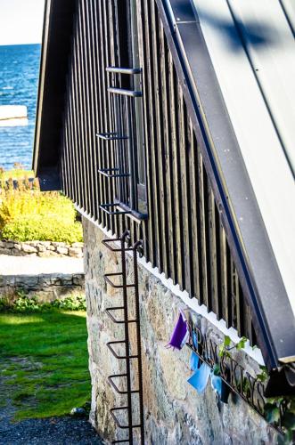 a metal railing on a wall with graffiti on it at Apan & Klyset in Simrishamn