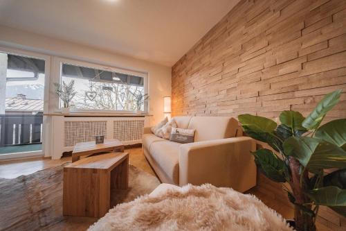 ein Wohnzimmer mit Sofa und Tisch in der Unterkunft Moderne Ferienwohnung mit Ifenblick, Panorama & Parkplatz in Oberstdorf