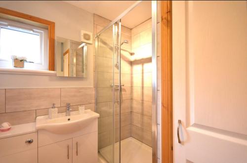 a bathroom with a sink and a shower at Cozy 1 bed flat in Stornoway in Stornoway