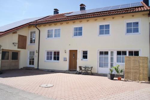 a large white house with a brick driveway at Alte Malerei in Peiting