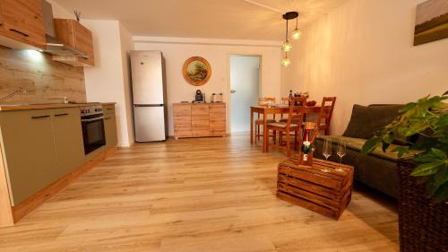 a living room with a couch and a kitchen at Alte Malerei in Peiting