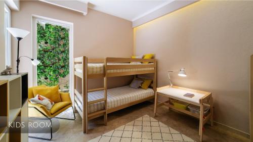 a room with two bunk beds and a chair at Private Terrace Living - Blue Flag Beach & Family Retreat near Kotor in Gornji Orahovac