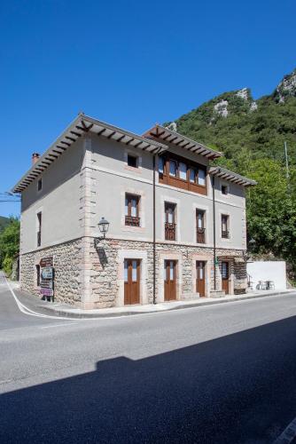 a large stone building on the side of a road at Hotel Boutique Las dos Peñas in Mier