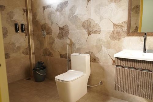 a bathroom with a toilet and a sink at Eleven Eleven Villa in Pondicherry