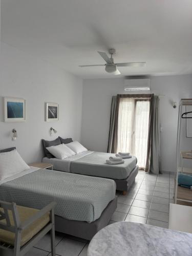 a bedroom with two beds and a couch at Moschoula Studios in Parikia