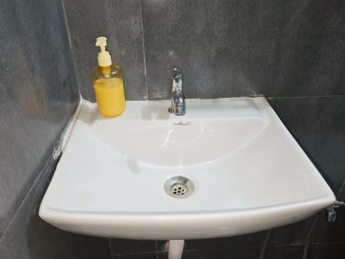 a white sink with a soap bottle on it at Chandrachhaya Agro Farms Boisar in Boisar