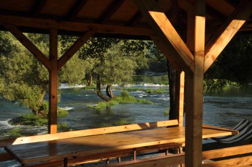a view of a river from a wooden gazebo at Kuća za odmor Komić in Smrdan