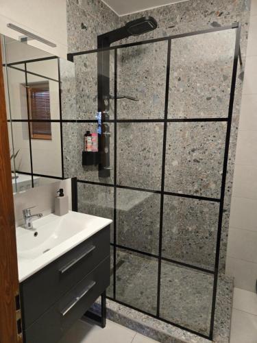 a bathroom with a shower and a sink at Maradj Még Vendégház in Balatonakarattya