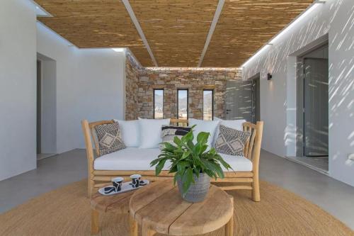 a living room with a couch and a table at Callirhoe 180 in Poros