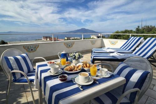 a table with plates of food on a balcony at Villa Raf in Vico Equense