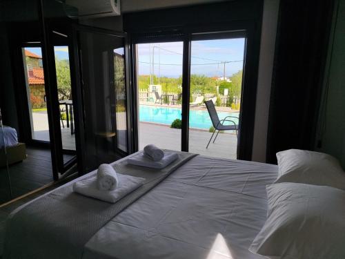 a bedroom with a bed with towels on it at Silia Villas in Ormos Panagias