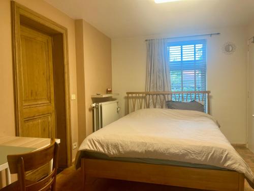 a small bedroom with a bed and a window at SomeTimes in Roeselare
