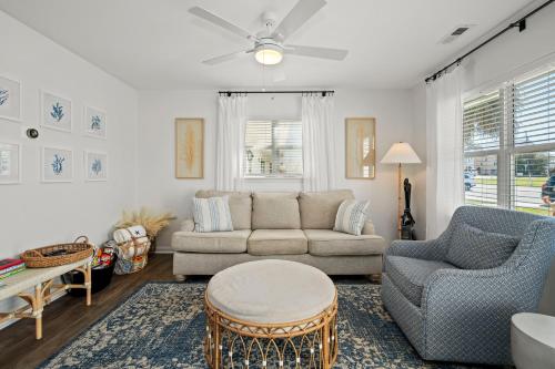 a living room with a couch and chairs and a table at The Crabby Seahorse in Emerald Isle