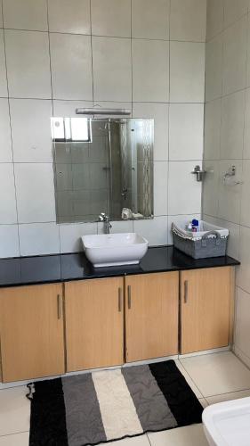 a bathroom with a sink and a mirror at Karibu comfort in Kisumu