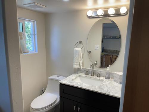 a bathroom with a sink and a toilet and a mirror at Rustic Ridge in Granite Dells in Prescott