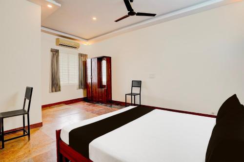 a bedroom with a bed and a ceiling fan at SPOT ON Sj Comforts Boarding And Lodging in Jigani