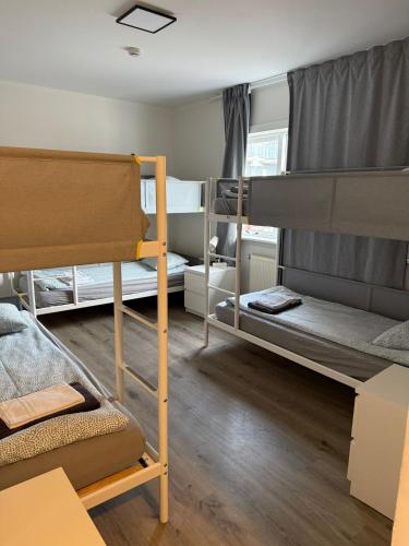 a room with two bunk beds and a table at Whale House in Keflavík