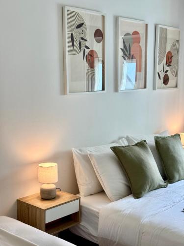 a living room with a couch and four pictures on the wall at Aura Campo de Ourique - Near the Tram 28 stop in Lisbon